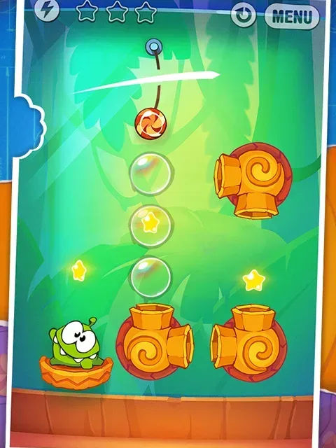 A Cut the Rope: Experiments GOLD board: a candy hanging from a rope above the green creature, with brass suction pipes on a wooden shelf.